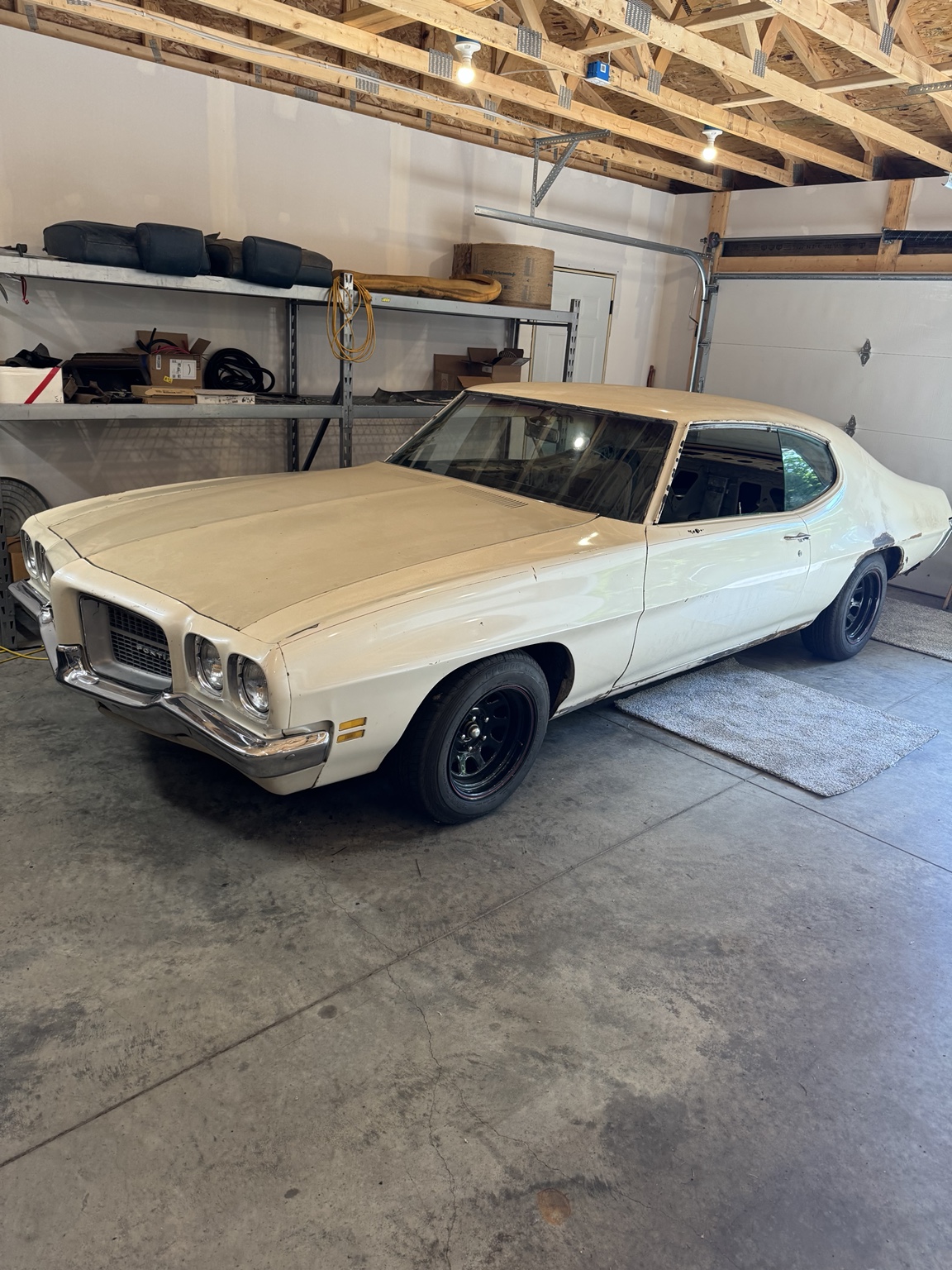 Zak’s cream-colored 1971 Pontiac LeMans, viewed from the front in his garage.